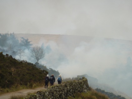 People walking down our track into the smoke.